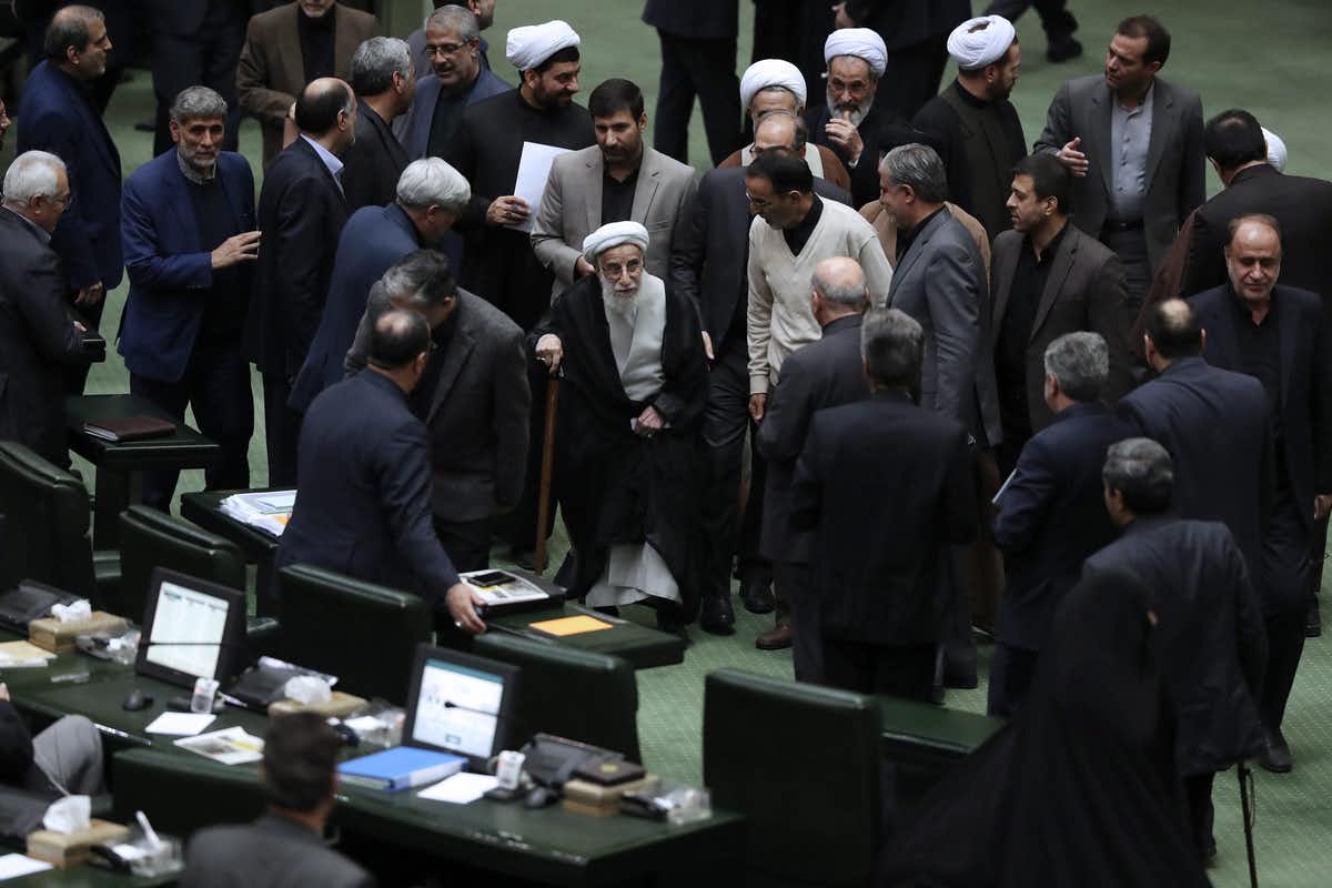 Ayatollah Ahmad Jannati, centre, arrives at Iran’s parliament for a debate on a bill declaring the U.S. military’s command at the Pentagon in Washington and those acting on its behalf terrorists subject to Iranian sanctions in January 2020. (AP Photo/Vahid Salemi)
