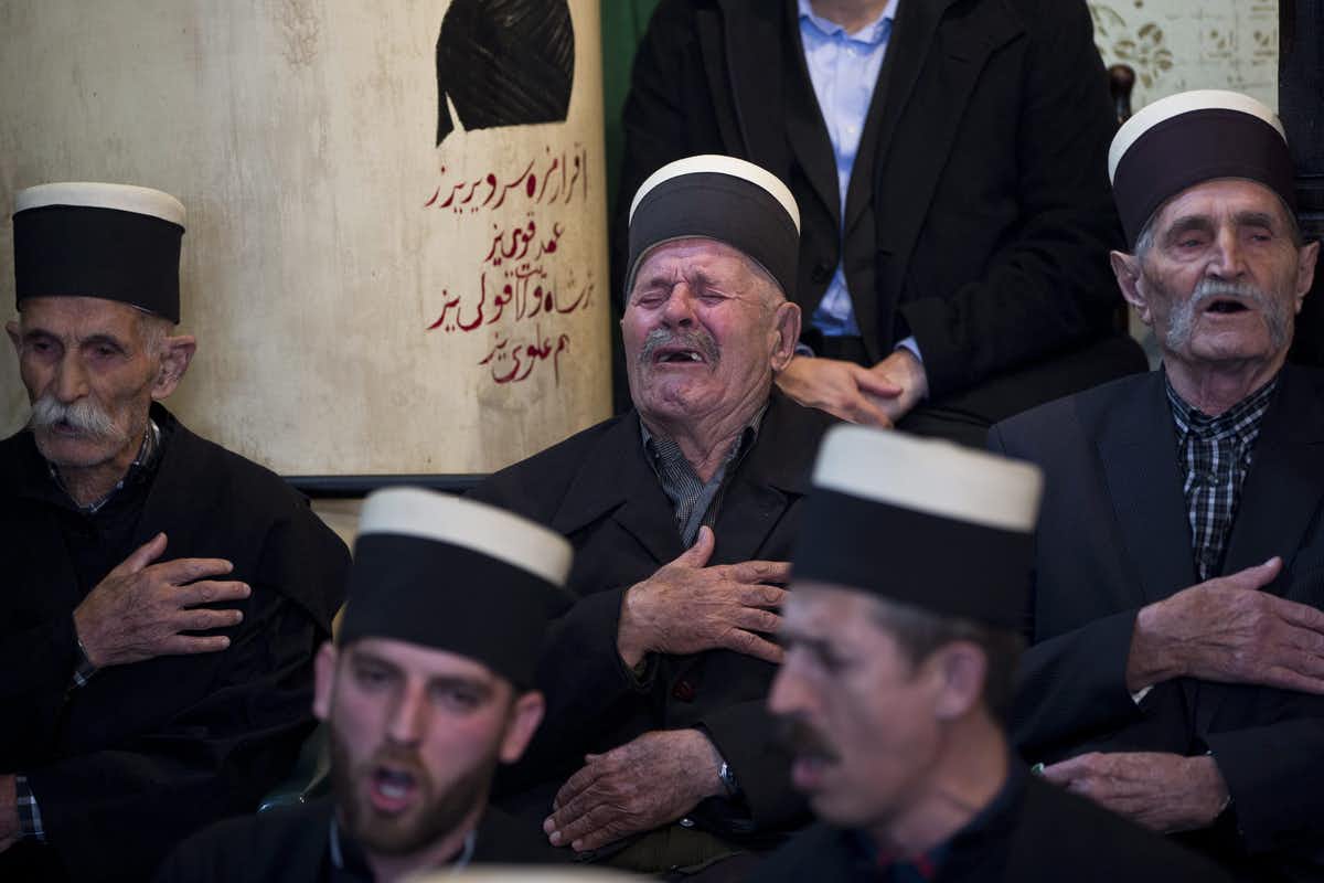 Dervishes, followers of Sufism — a mystical form of Islam that preaches tolerance and a search for understanding — pray during a ceremony in southern Kosovo in March 2018. (AP Photo/Visar Kryeziu)