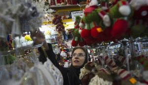 Iranian-Christian woman looks at Christmas decorations while shopping in central Tehran