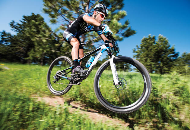 Professional mountain biker Sina Solouksaran catches air while going over a bump on a trail in White Ranch Open Space Park near Golden, Colorado, Friday June 24, 2016. Solouksaran, a refugee originally from Iran after being banned from biking due to not being a practicing Muslim, now lives and trains in Golden after living in Turkey for a couple years. Photo by Matt Nager