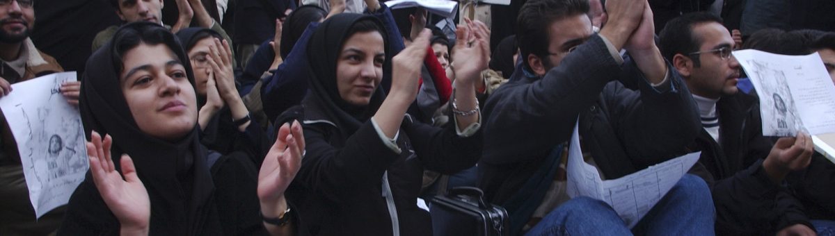 In this Dec. 7, 2003 photo, female Iranian university students, along with male students, attend a gathering to mark national annual Student Day, at Tehran University campus in Iran. Image via AP.