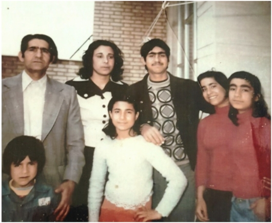 Photo of Ziaullah Haghighat, 47, with his wife and children. Afshin, 8, is standing in front of his father. This photo was taken forty days before the killing of Ziaullah.
