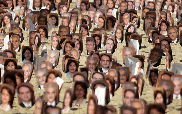 PROTEST: Photos of Baha'i religious leaders who have been arrested in Iran. Protesters arranged them on Brazil's Copacabana Beach in 2011. REUTERS/Stringer