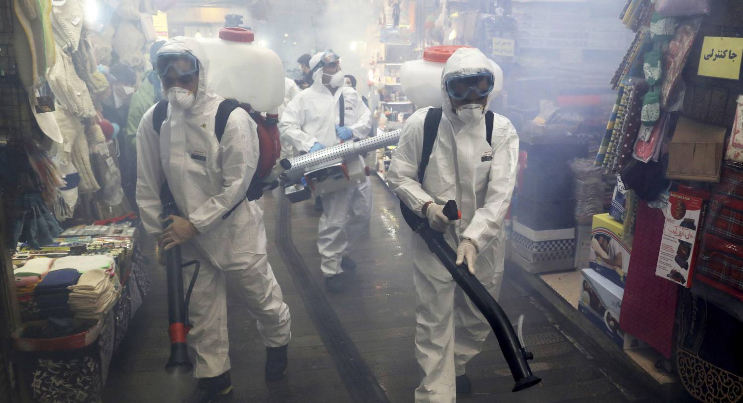 Firefighters disinfect a shopping centre in northern Tehran. Despite a potential second wave of coronavirus infections (new cases have averaged around 2,500 a day since the start of June) a new wave of arrests has targeted at least 77 Bahá’í’s. Picture: Ebrahim Noroozi/AP
